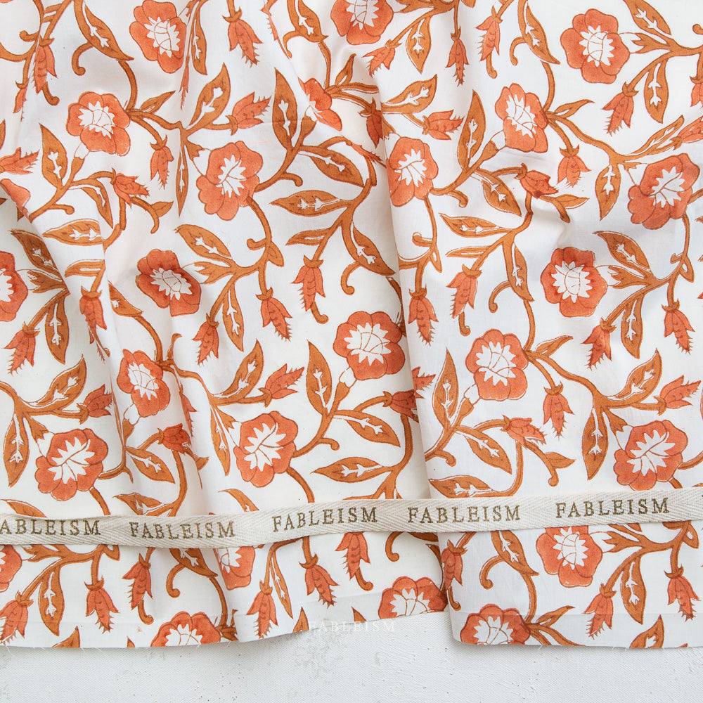 Floral patterned fabric with 'Fableism' branding on a white background