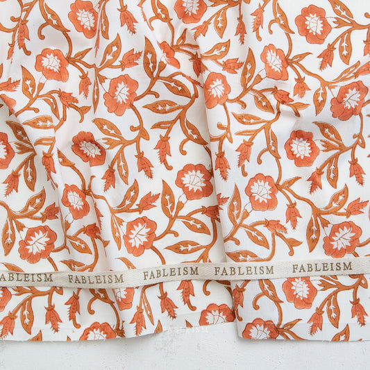 Floral patterned fabric with 'Fableism' branding on a white background