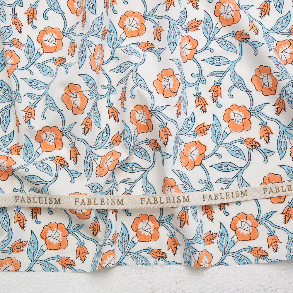 Floral patterned fabric with 'Fableism' branding on a white background