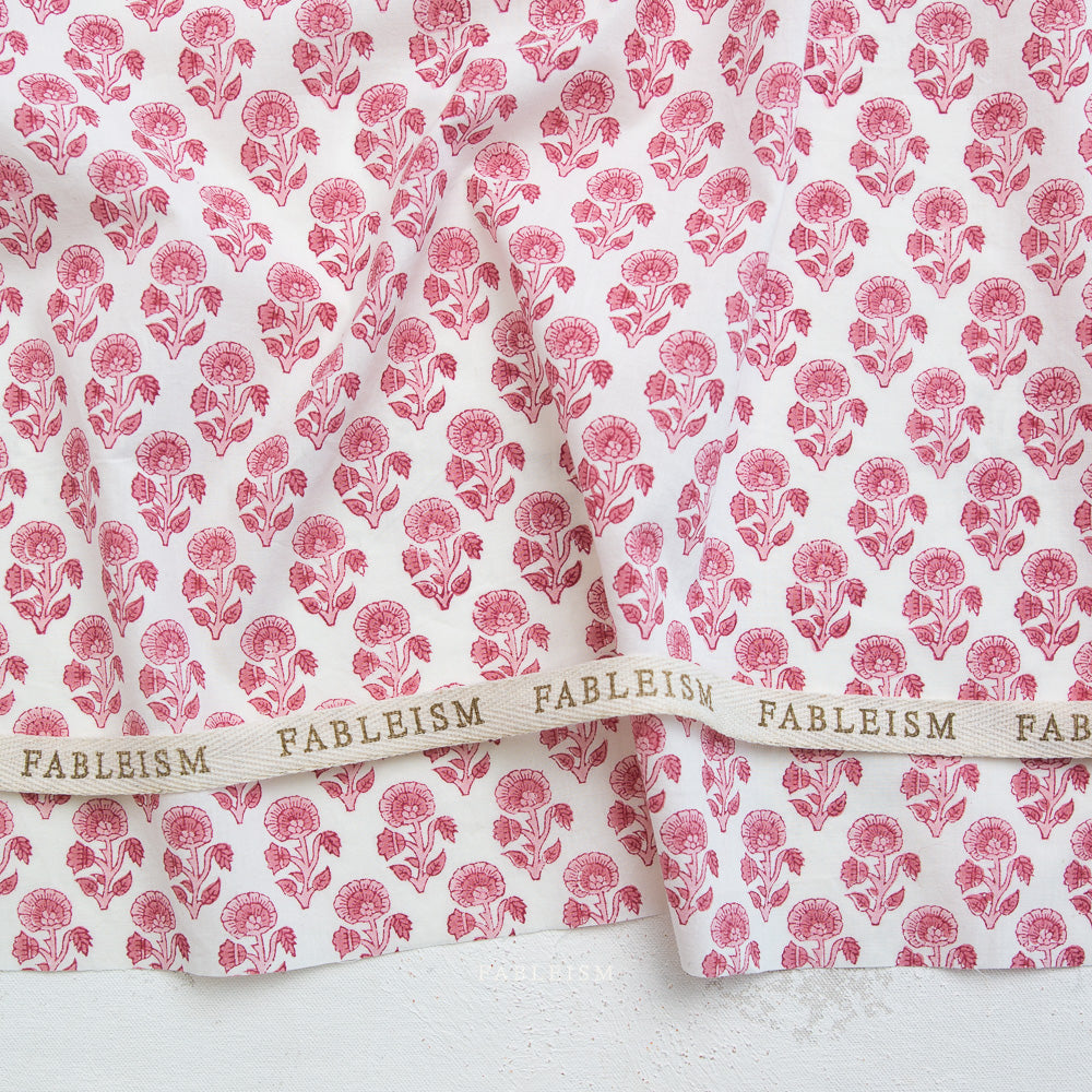 Fableism fabric with pink floral pattern on a white background
