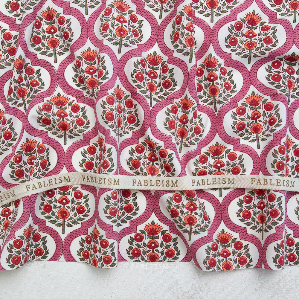 Patterned fabric with red floral design and 'Fableism' branding.
