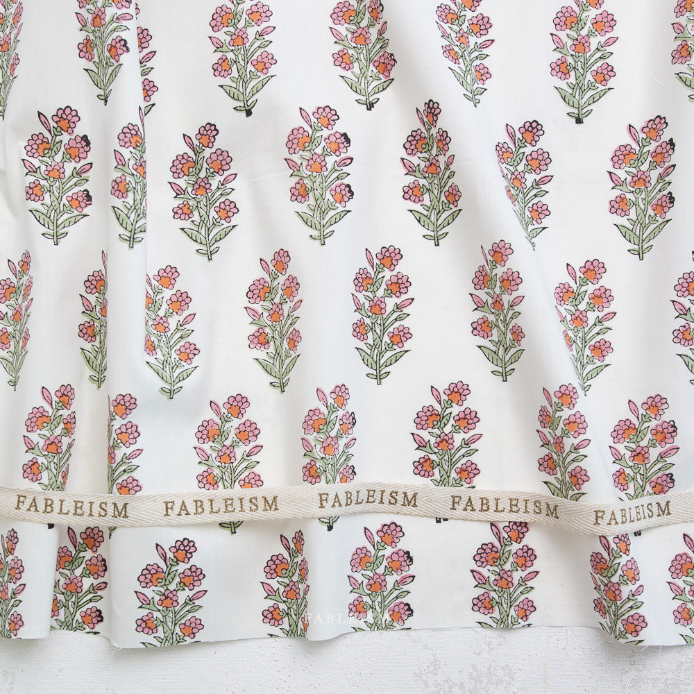 Floral patterned fabric with 'Fableism' branding on a white background