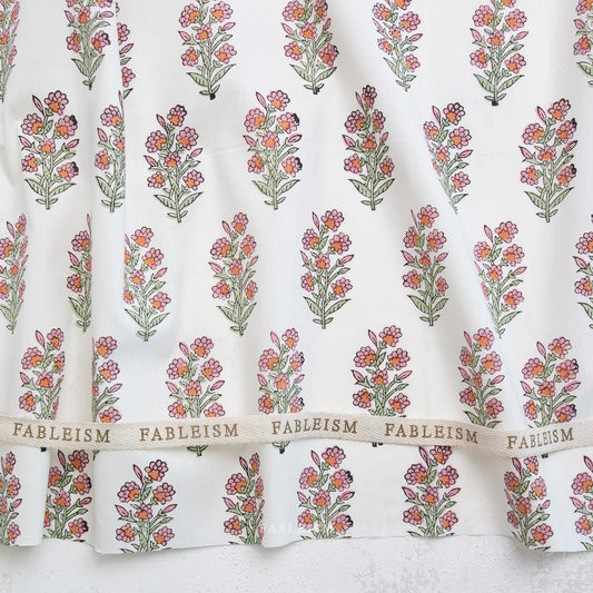 Floral patterned fabric with 'Fableism' branding on a white background