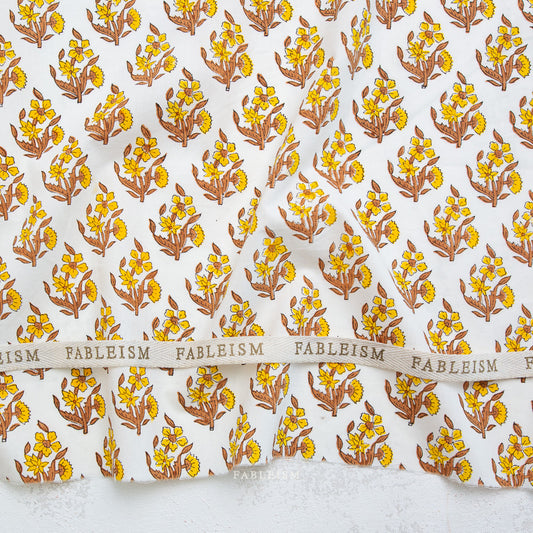 Floral patterned fabric with 'Fableism' branding on a white background