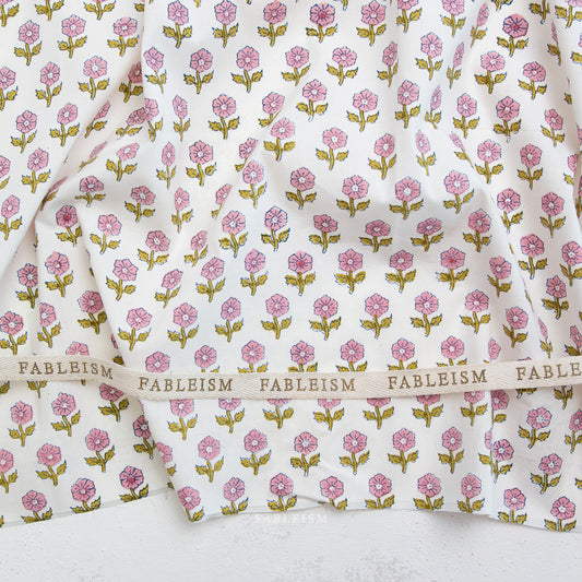 Floral patterned fabric with 'Fableism' branding on a white background