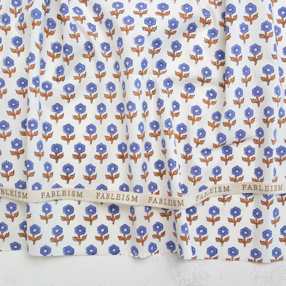 Floral patterned fabric with 'Fableism' branding on a white background