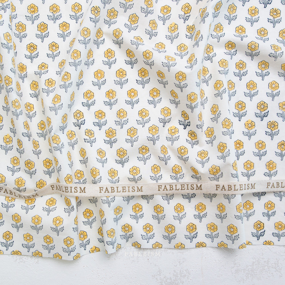Floral patterned fabric with 'Fableism' branding on a white background