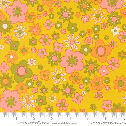 Pink, green, and orange floral pattern on a citrine background with Moda ruler below