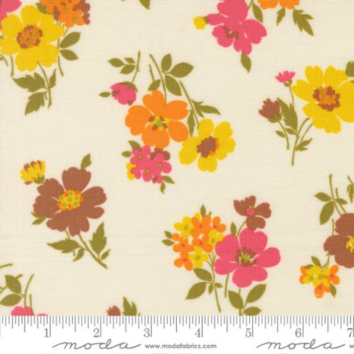 Pink, yellow, orange, and brown flowers with green stems on a cream colored background with Moda ruler at the bottom