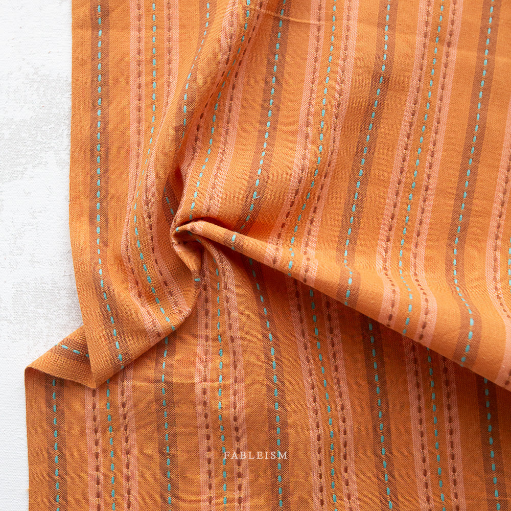 Peach and orange stipes with blue stitches