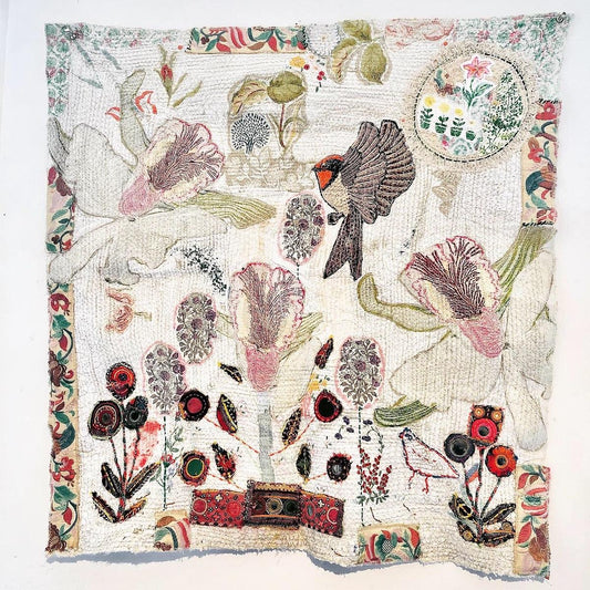 hand stitched textile art with flowers and birds