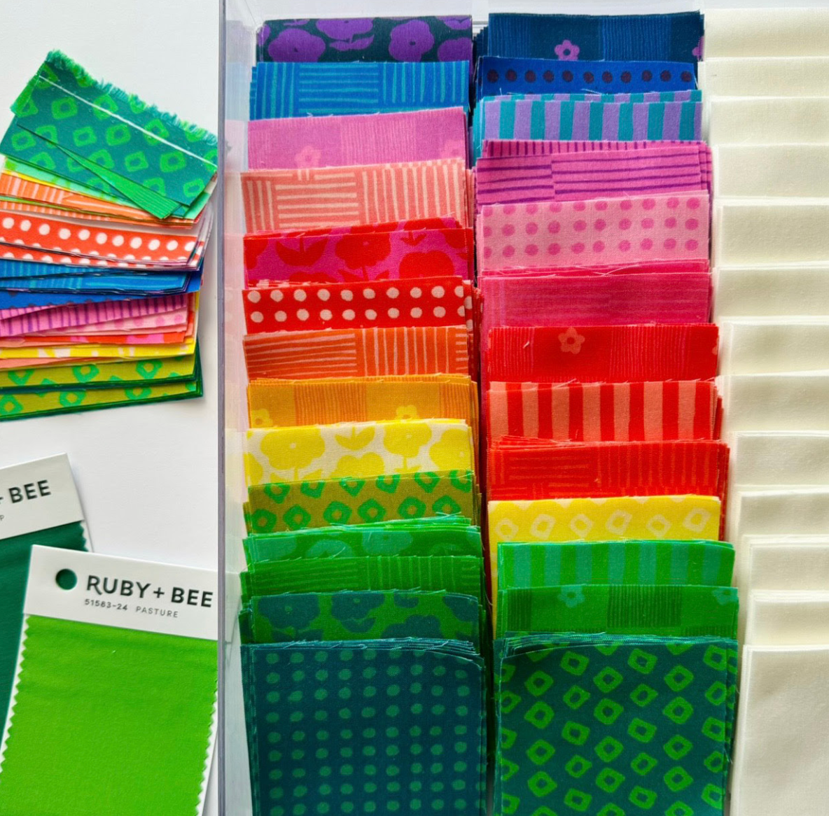 images of fat quarter bundles are shown. colors range throughout the rainbow: blue, purple, pink, orange, red, yellow, green, dark green. Designs range from dots to shibiro to drawn stripes, woven cross hatch pattern, puffy daisies, and daisies & lines. 