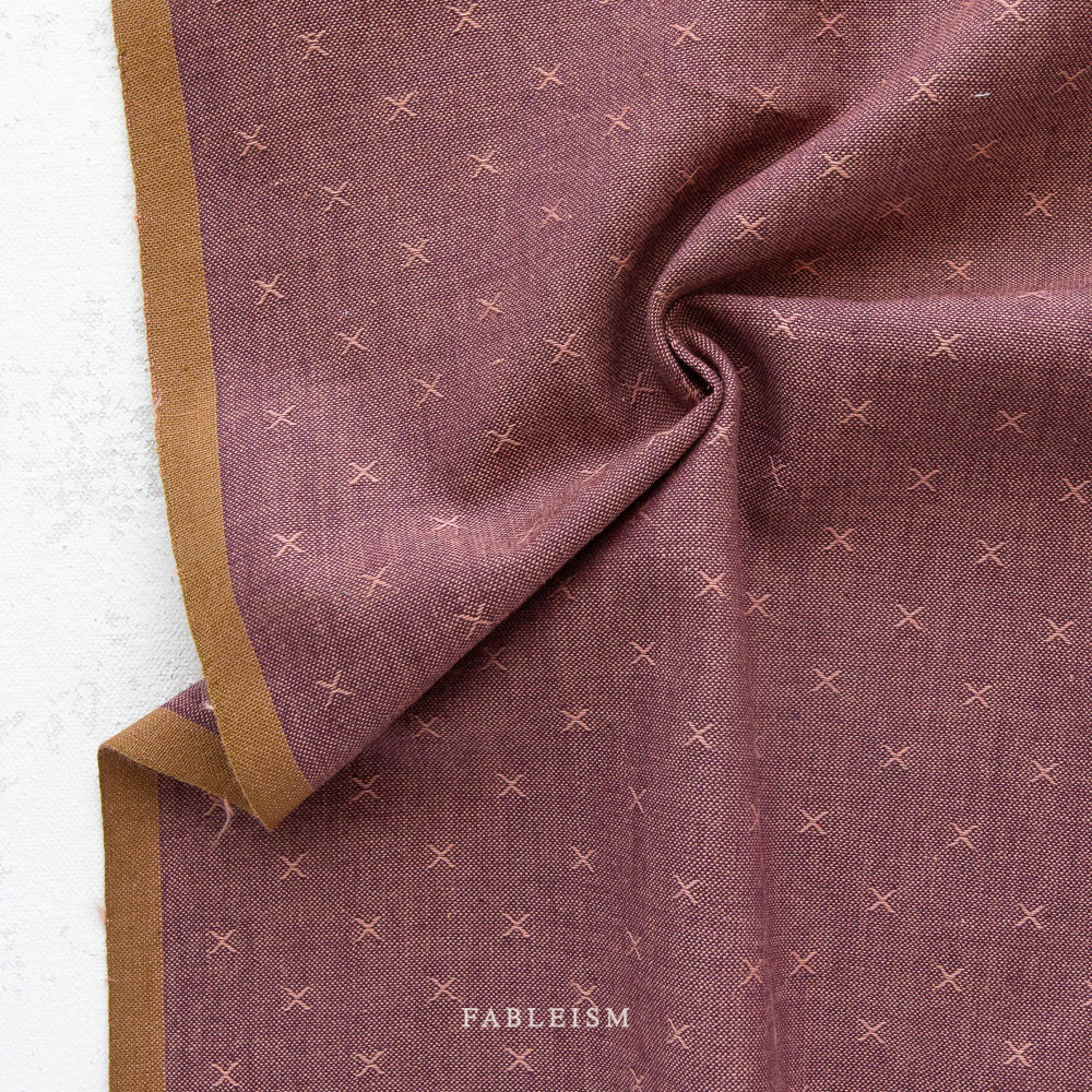 Plum fabric with embroidered x