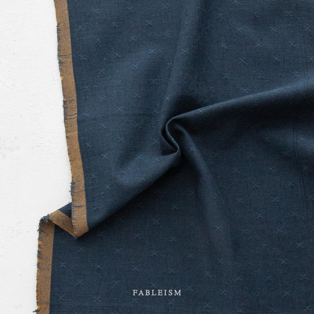 midnight blue fabric with embroidered x