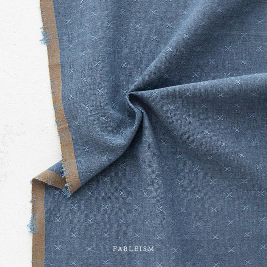 Blue texture fabric with a brown border against a white background