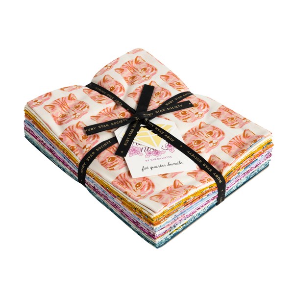 Stack of fabric squares tied with a black ribbon on a white background