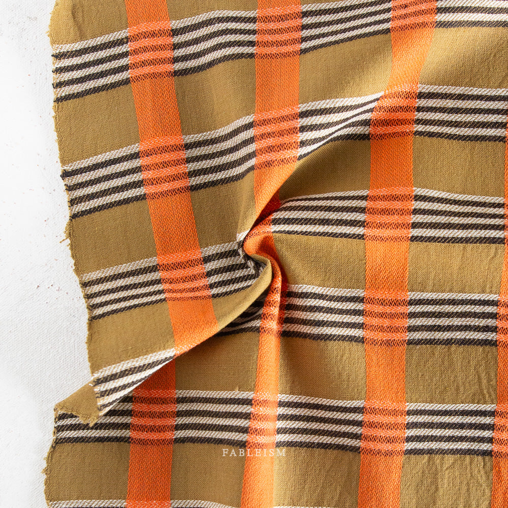 stripes in black, white and orange on olive