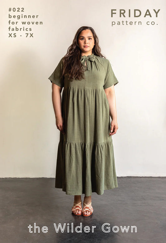 Woman wearing a green dress with 'Friday Pattern Co.' branding and product details.