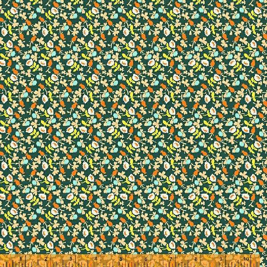A calico fabric with small white flowers  with orange, blue and yellow accents, against a dark background